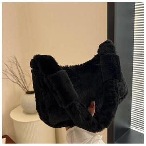 Detailed view of black plush faux fur shoulder bag with soft texture and knotted handle