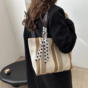 Fashionable striped canvas tote bag with large capacity and a stylish polka dot scarf detail