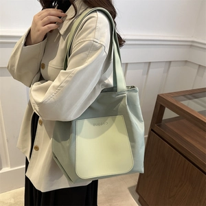 Retro aesthetic two-tone tote bag in sage green and cream with casual shoulder strap