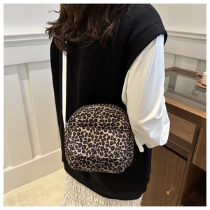 Detail of trendy leopard print crossbody bag with white shoulder strap and mini square shape