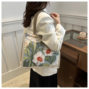 Artistic tote bag featuring a 3D embossed floral design on premium cream canvas fabric