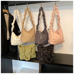 Detail showing various colors of quilted bow tote bags with ruffled shoulder straps