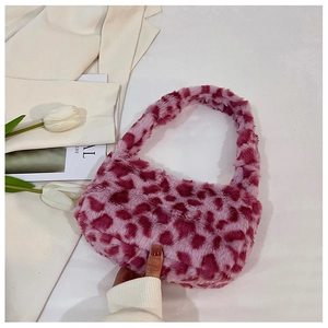 Detail of soft faux fur shoulder bag with pink and purple leopard print pattern