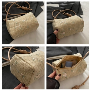 Detail views showing floral embroidery on a cylinder straw bag and inner zipper pocket