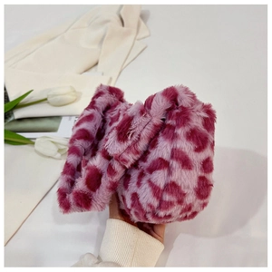 Detail of soft faux fur shoulder bag with stylish pink and purple leopard print texture
