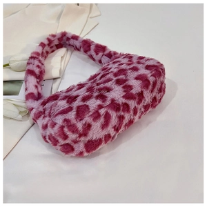 Close-up of plush leopard print shoulder bag in pink and purple with soft texture