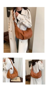 Close-up of a caramel brown pleated crescent bag with knotted shoulder strap details