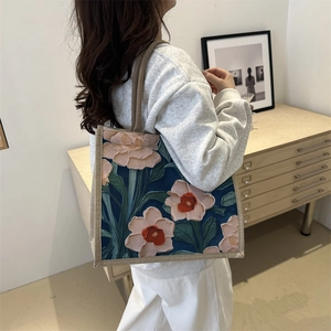 Artistic navy canvas tote bag with 3D floral embroidery and beige woven handles