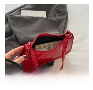 Internal capacity of the red patent leather crescent bag showing space for a smartphone