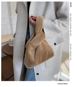 Detailed close-up of brown faux fur knot bag texture paired with a winter wool coat