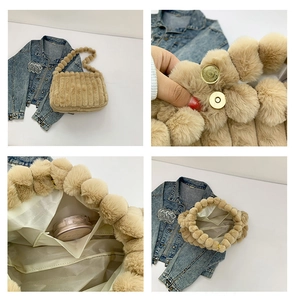 Detail of beige plush tote bag with vertical textures and fluffy ball strap