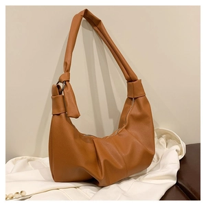 Detail of soft brown pebble texture and stylish knot buckle on the pleated crossbody bag