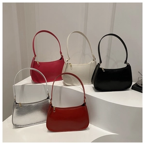 Macro view of minimalist crescent bags in five colors with golden zipper details