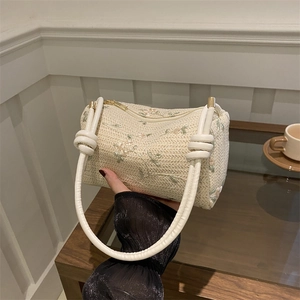 Fashionable woven pillow bag with floral embroidery and knotted strap for women