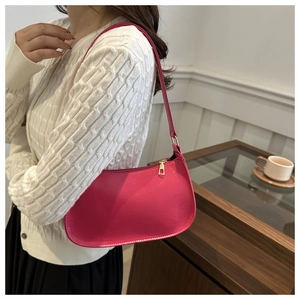 Detail showing high-gloss magenta hobo bag with gold zipper and smooth PU texture