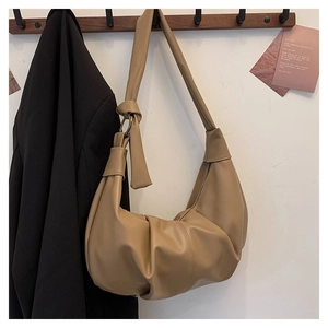 Detail of khaki pleated dumpling bag with knot strap and textured faux leather finish