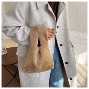 Detailed view of caramel faux fur handbag with a unique single knot handle design