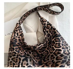 Close-up of leopard print tote bag showing premium leather grain and handle details