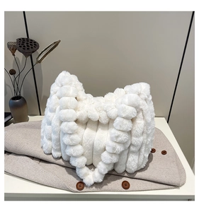 Close-up of white plush tote bag with unique bubble texture and soft faux fur material