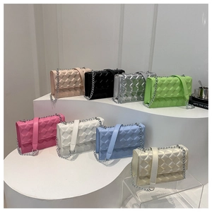 Detail of multi-color quilted leather small square bags with silver chain straps