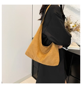 Dettaglio della borsa tote in pelle opaca giallo senape con tracolla larga