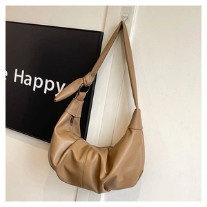 Detailed macro view of the pleated khaki hobo bag with refined lychee leather texture