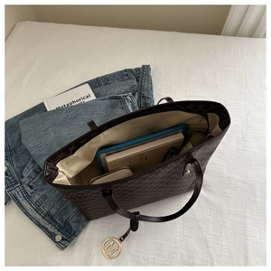 Detail view of large tote bag interior showing ample space for tablets and wallets