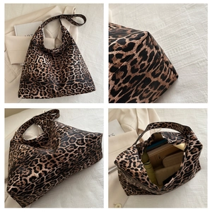 Macro detail of leopard print tote bag showing spacious interior and stitching details