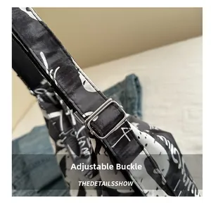 Detail of adjustable metal buckle on printed canvas strap for versatile backpack
