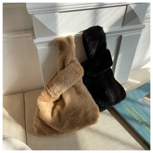 Detailed texture of black and khaki faux fur knot bags in a cozy lifestyle setting