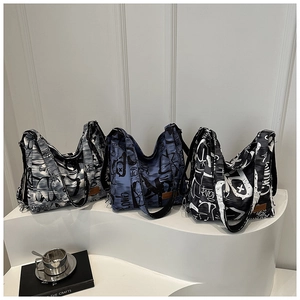 Three canvas tote bags with graffiti prints and leather labels shown in a clean setting