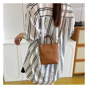 Brown litchi leather mini tote bag with crossbody strap and Fashion logo detail