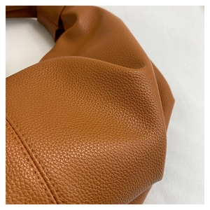 Macro view of premium brown lychee texture leather with precise stitching details