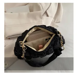 Detail shot showing the large interior capacity of the black pleated cloud shoulder bag