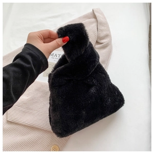 Detail showing plush black faux fur texture and soft handle of the chic autumn winter handbag