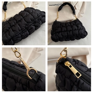 Detail of black quilted cloud bag showing soft puff texture and gold metal chain strap