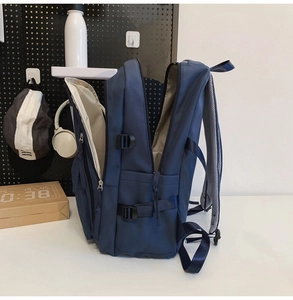 Detail view of the large capacity dark blue backpack with multiple zippered compartments