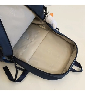 Detail of navy backpack interior with laptop compartment and multiple functional pockets