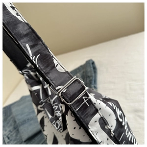 Macro shot of adjustable silver metal buckle and artistic print canvas shoulder strap