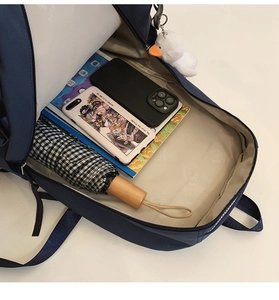 Detail view of navy blue backpack interior with laptop compartment and large storage space