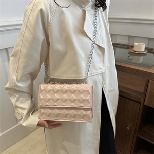 Elegant cream quilted crossbody bag with silver chain strap for chic autumn daily commute