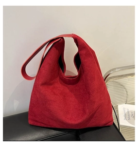 Close-up of red suede tote bag texture and spacious interior for daily commute