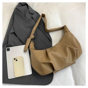 Detail of camel hobo bag showing pleated faux leather texture and side knot detail