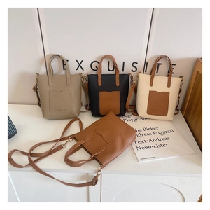 Close-up of stylish mini tote bags with lychee leather texture and FASHION stamp