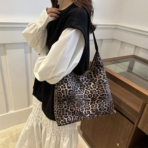 Chic leopard print large tote bag for women worn by a model in a minimalist setting