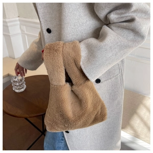 Detailed close-up of a camel plush faux fur tote bag styled with a wool coat for winter