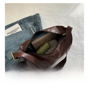 Top view of spacious interior in soft dark brown leather tote bag with zip closure