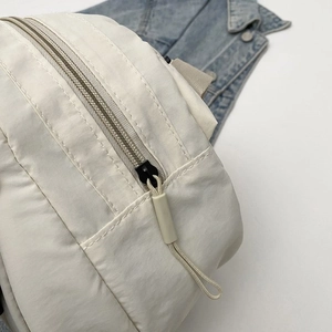 Close-up of durable white fabric texture with black zipper and rope pull detail
