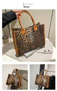 Macro view of leopard print texture and reinforced handles on a large tote bag