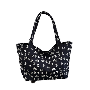 Large black tote bag with white bow pattern print and casual shoulder straps